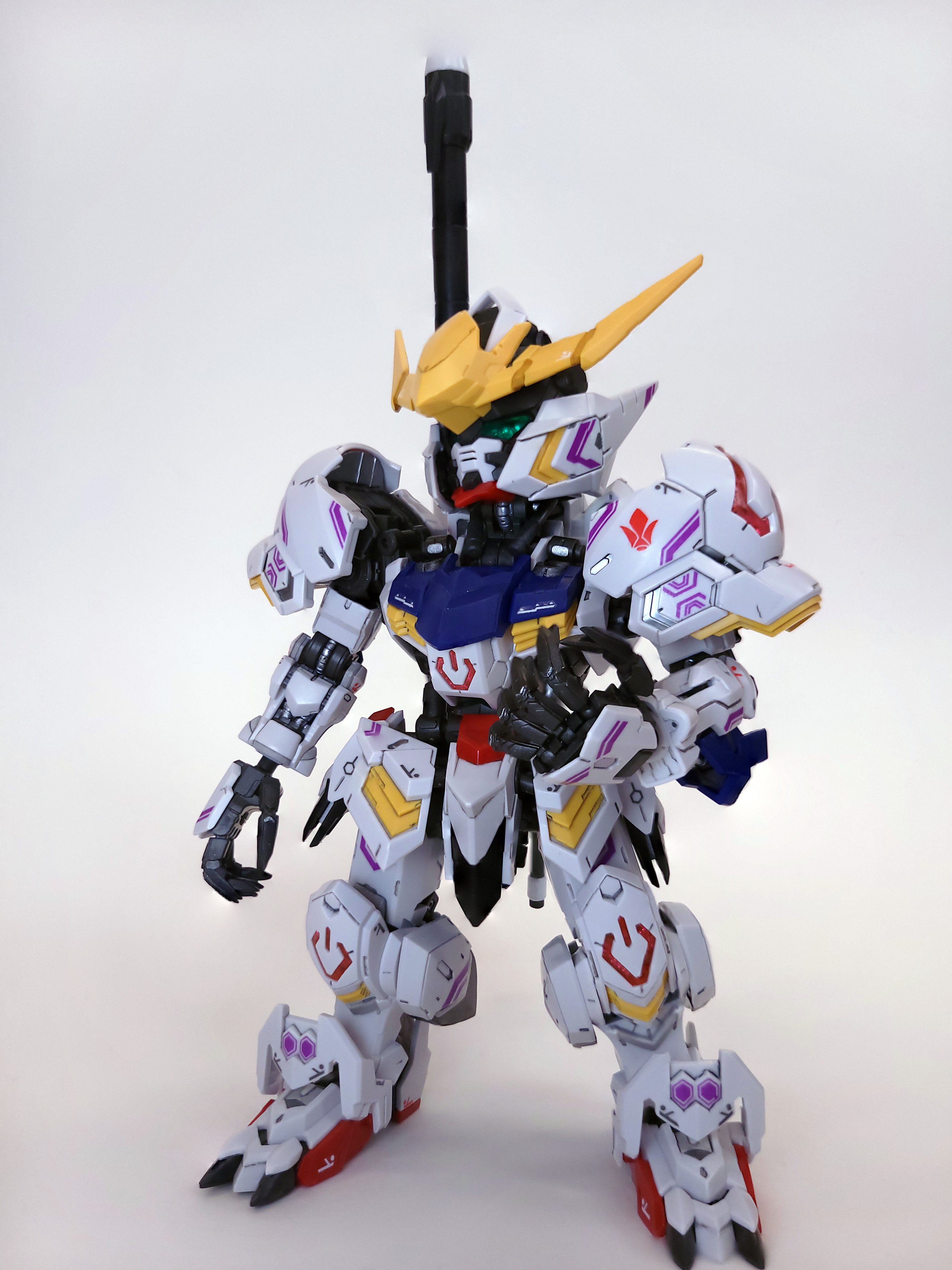 MGSD Barbatos stands, one hand lift expressively. Its head is cocked upwards and to the left, as if it was looking down its nose at you