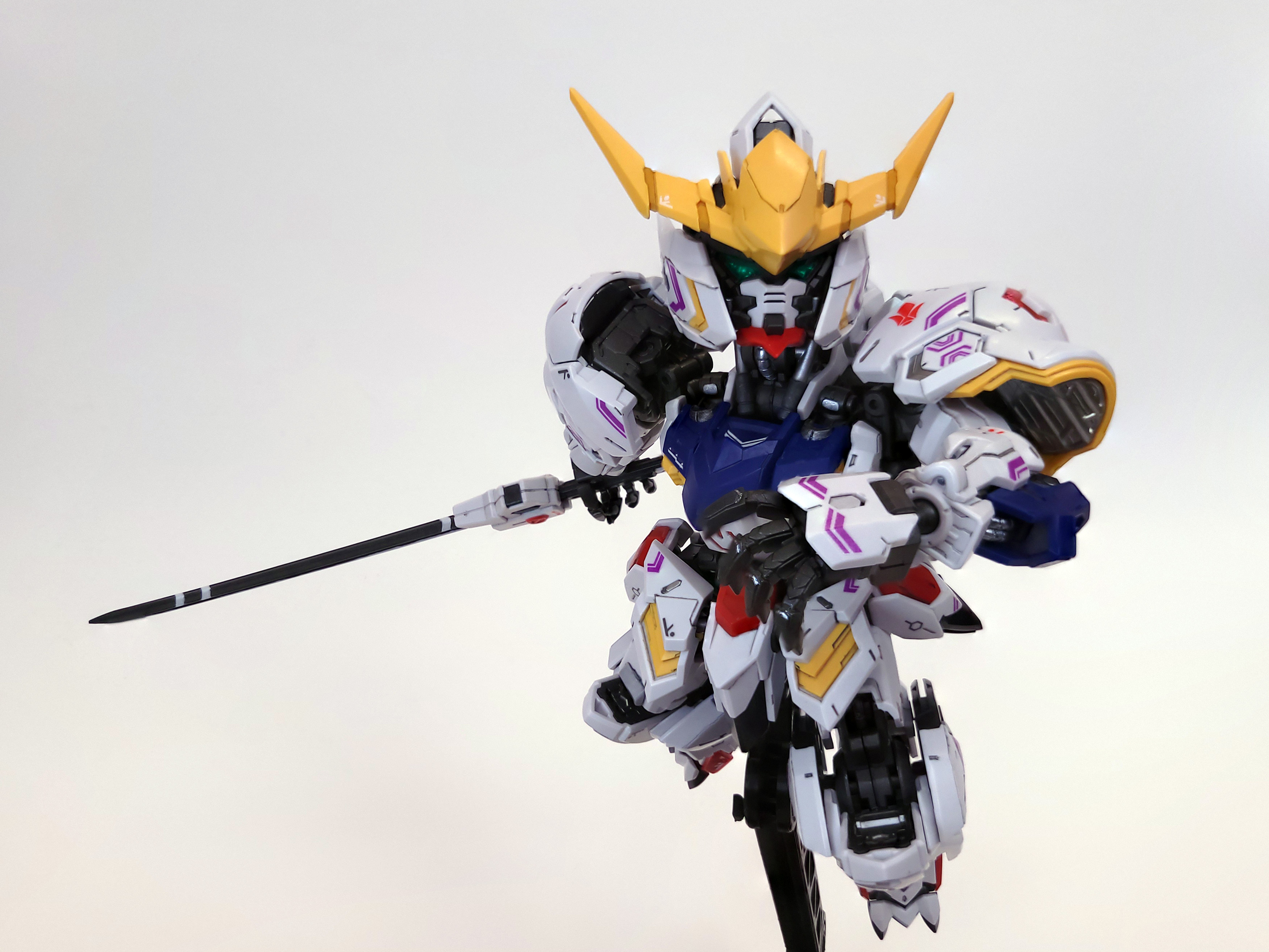 Barbatos leaps towards the camera, its katana trailing behind, an open hand reaching towards the viewer