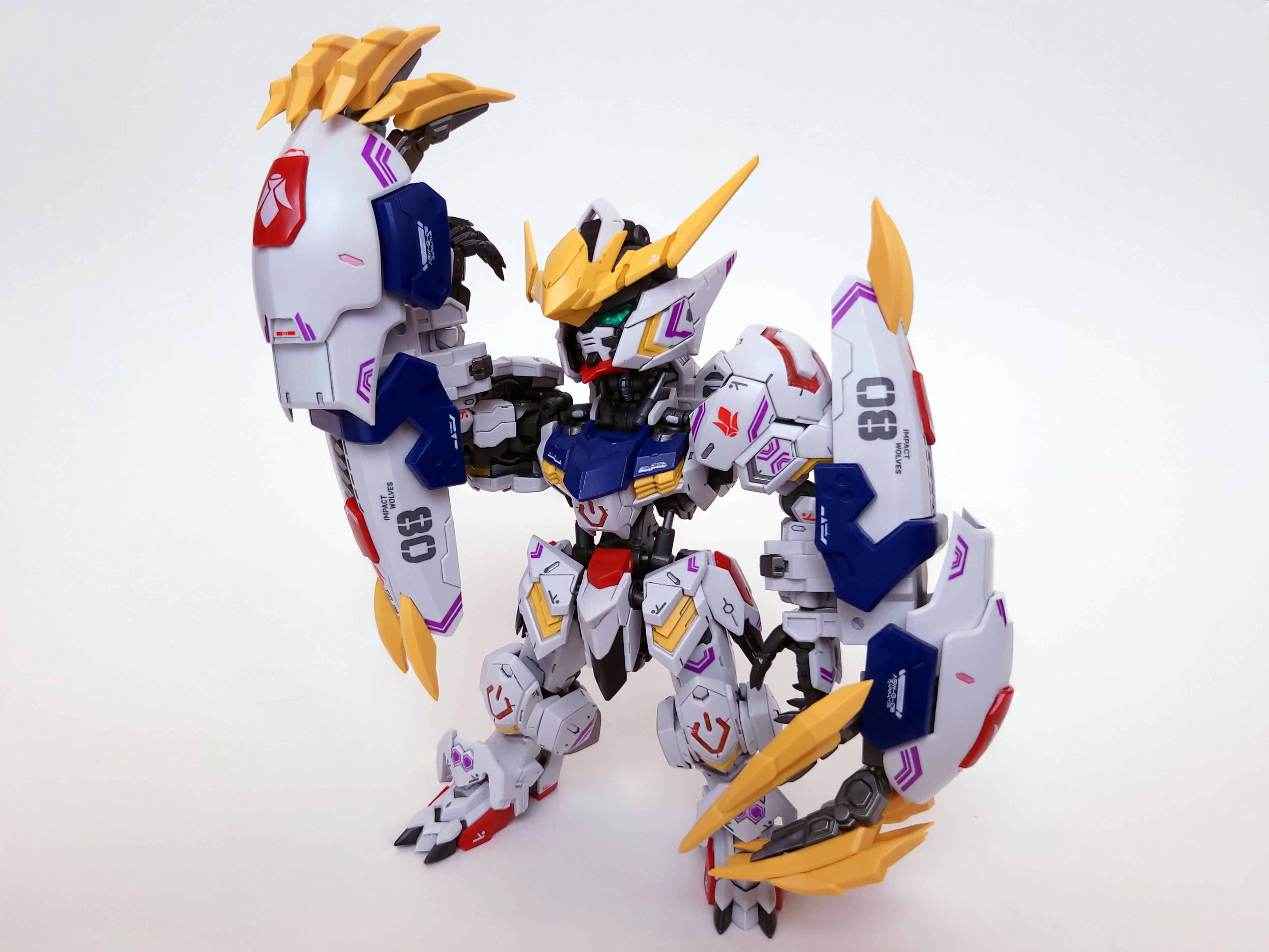 Barbatos stands, one arm lifted up to examine its hand, which is enveloped by a Massive gauntlet with huge yellow claws