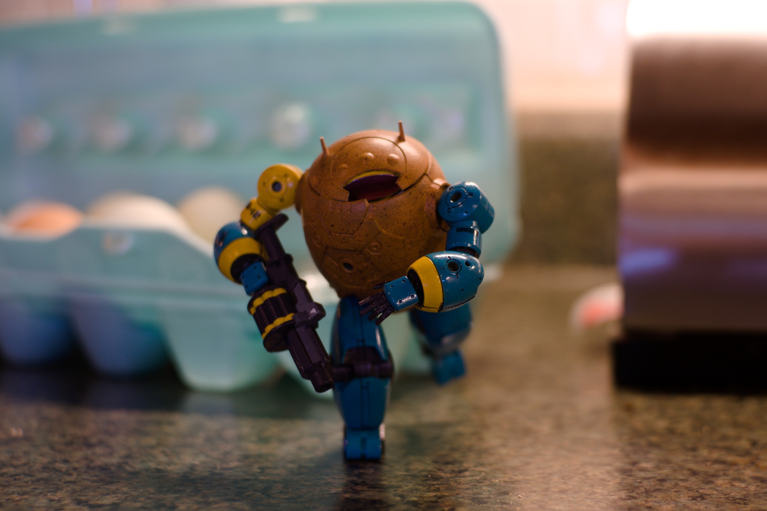 EGG-12 runs from an egg carton towards the camera. The diminutive hero looks very determined