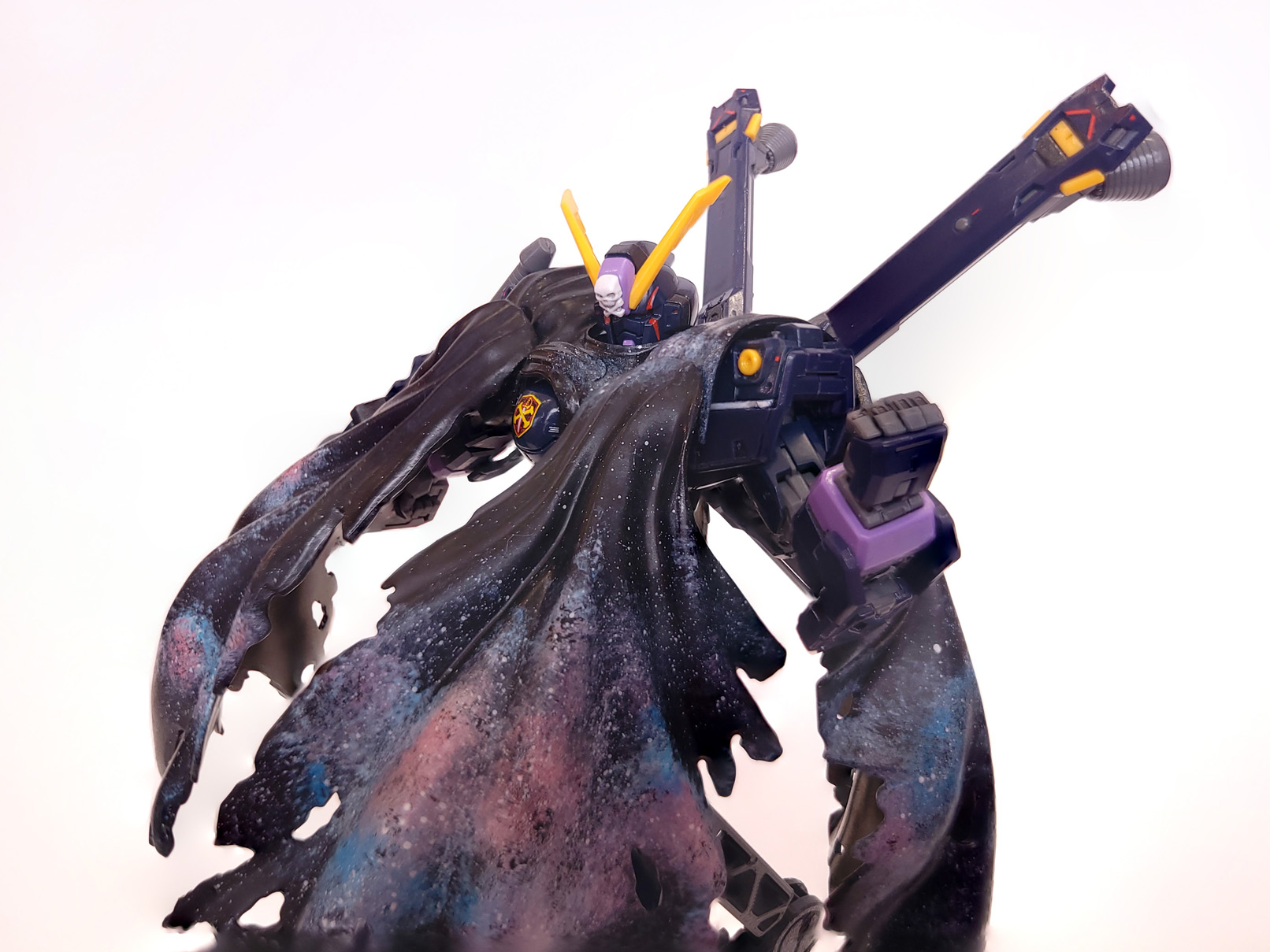 A closeup of the mech in its cloak, showing off the stars and blue and pink gas clouds of the nebula