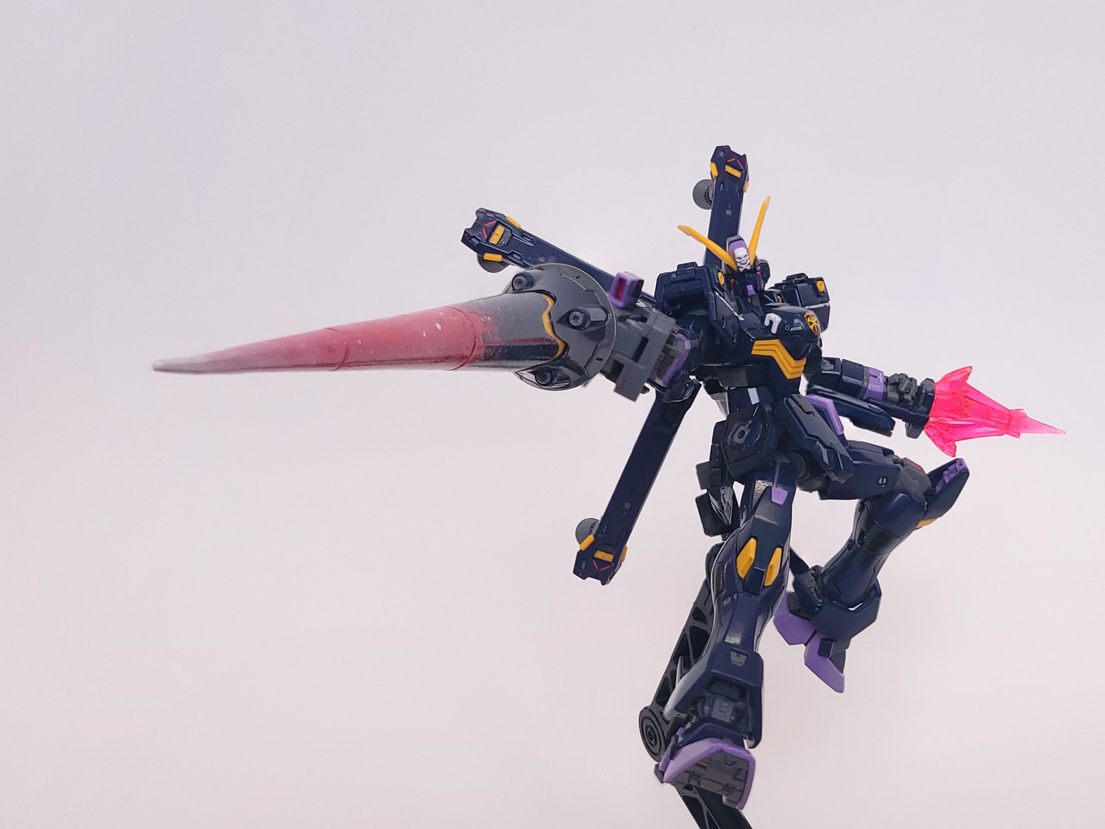 The uncloaked model robot hovvers limbs spread wide open, pointing its lance towards the forground. Its other hand has a bright pink energy effect erupting from it