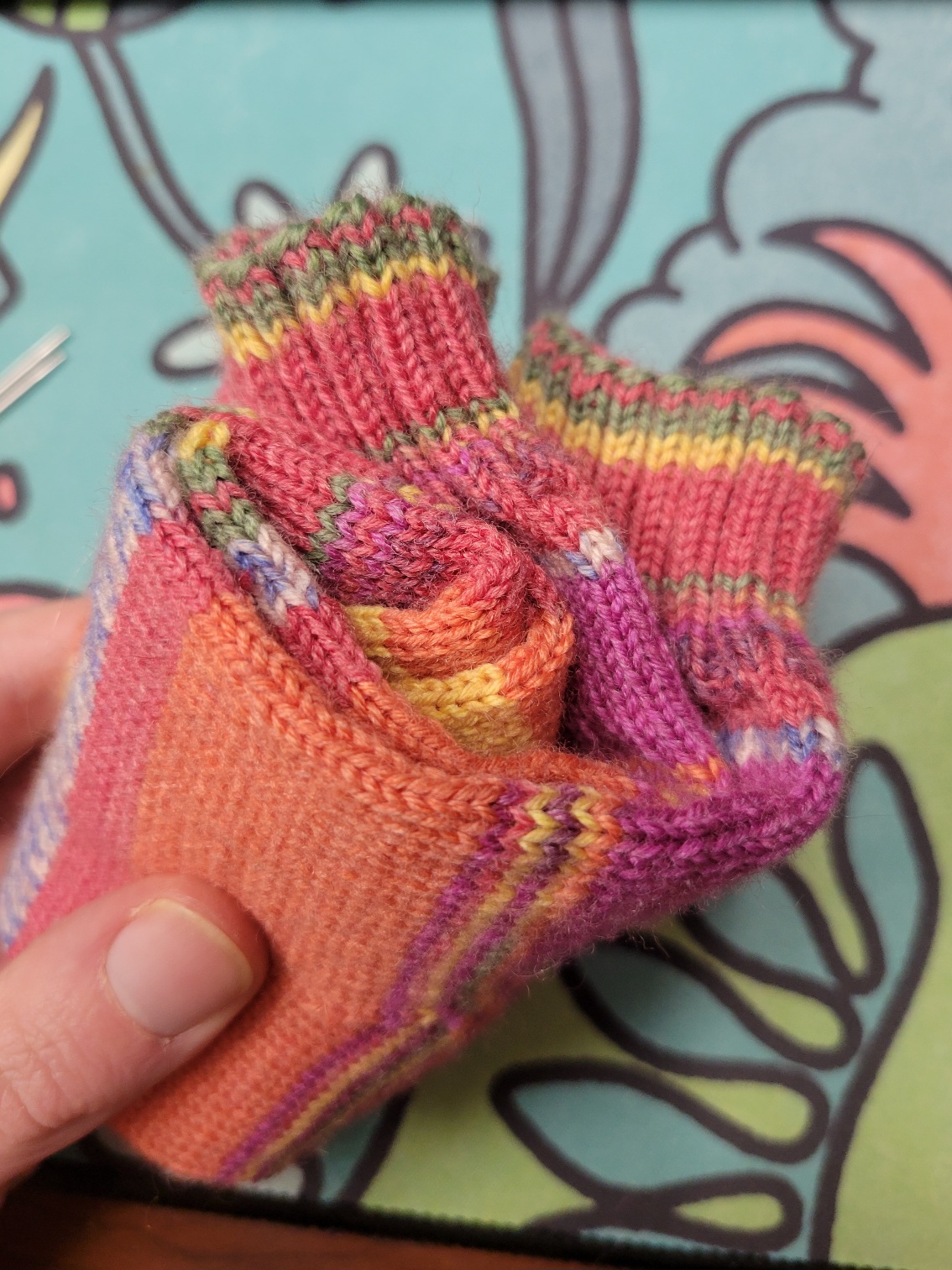 the pair of yellow/orange/pink socks rolled into a neat little spiral