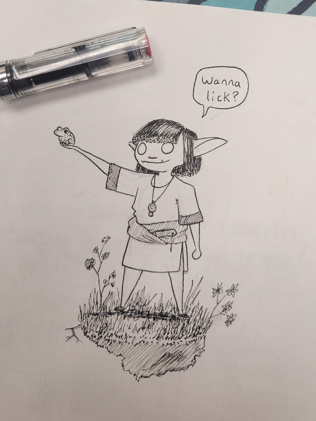 a small, stocky goblin with stiff straight hair holds up a frog asking, 'wanna lick?'