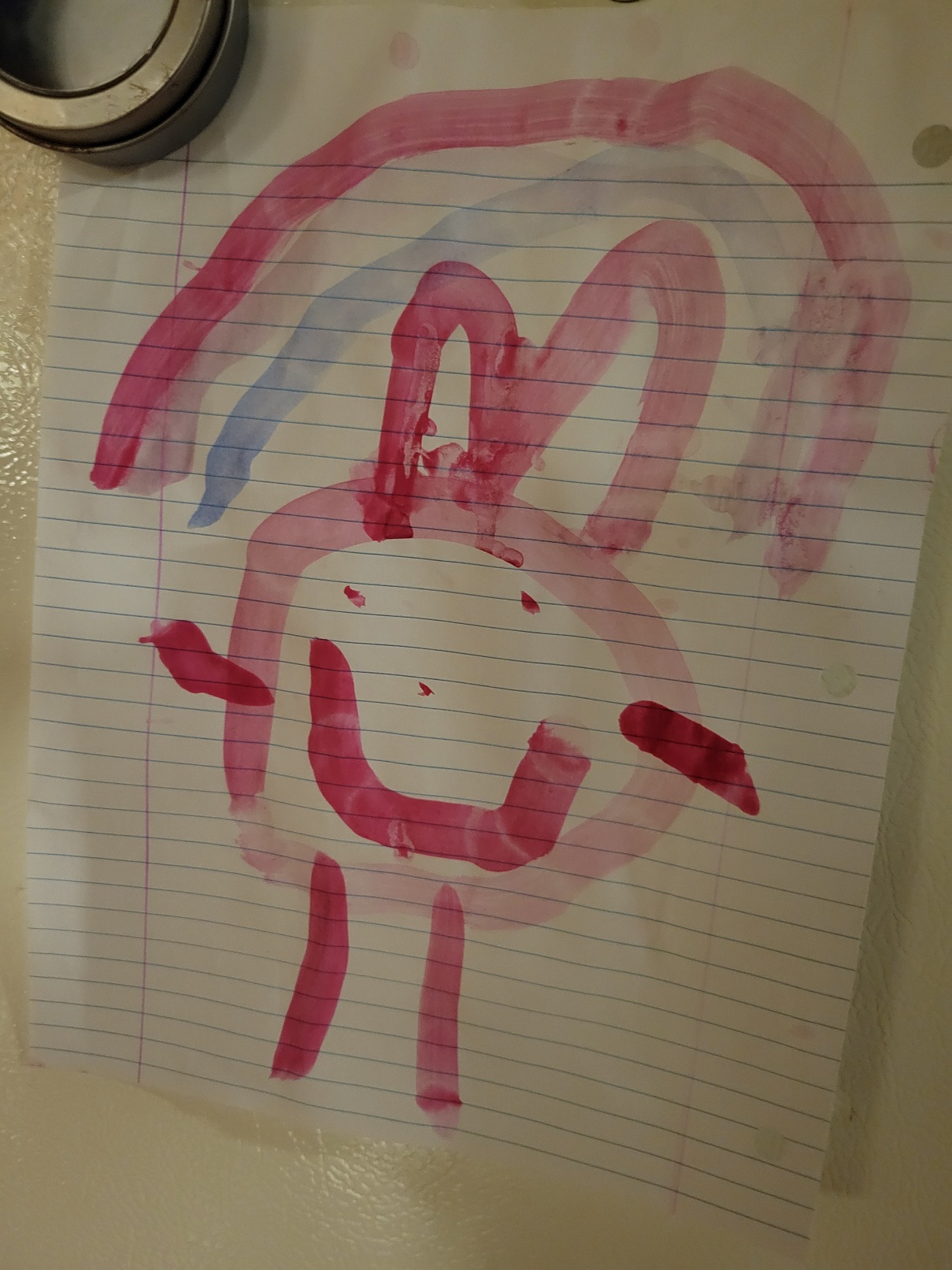 A 5 year old self portrait: a tadpole person with eyes, nose, and smile... and also bunny ears. A rainbow of three shades of pink/purple curves above the ears