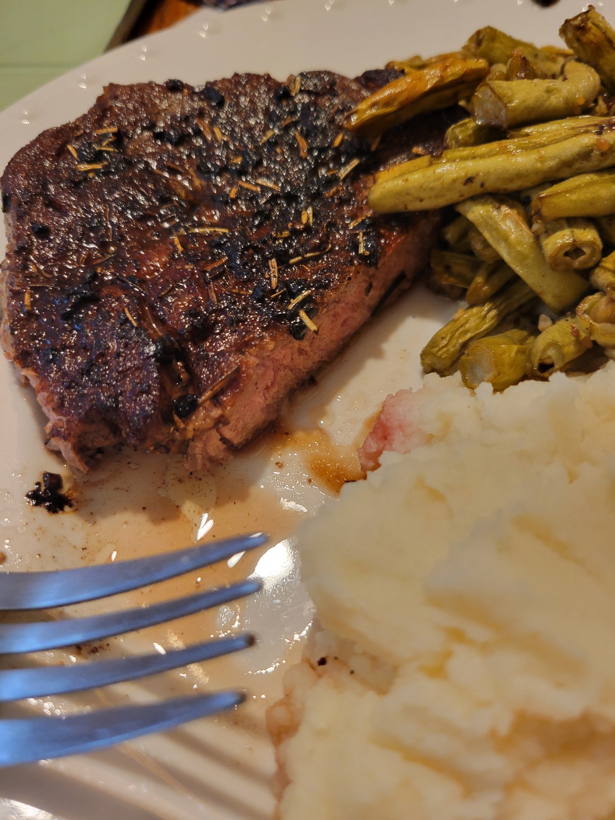 a gloriously seared steak with mashed potatoes and gravy