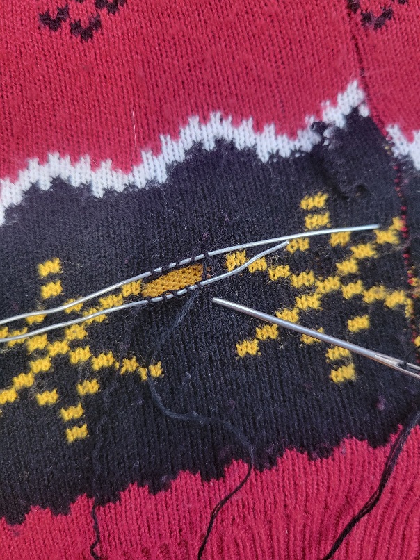 the hole in the knitting is partially grafted back together