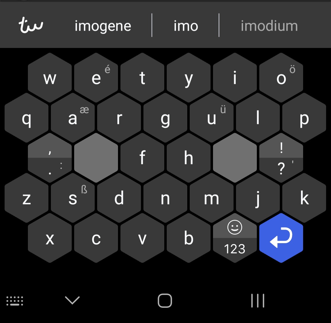 the typewise keyboard; each letter is part of a hexagonal grid; there are two spacebar buttons placed where a thumb would hover over a phone screen keyboard